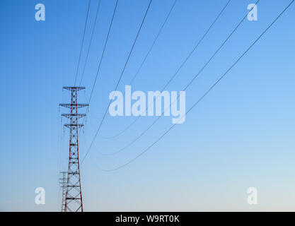 Hight-voltage electric power lines at sunset. Stock Photo