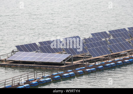 Solar cell panels installed on the space on the water surface. Stock Photo