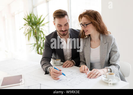 Two young architects working together in office Stock Photo