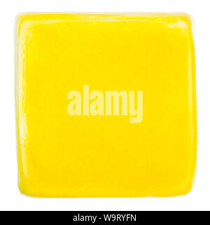 Yellow handmade glazed ceramic tile isolated on white background Stock Photo