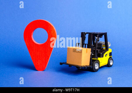 Yellow Forklift truck carries a box next to red pointer location. Services transportation of goods, products, logistics and infrastructure. Transporta Stock Photo