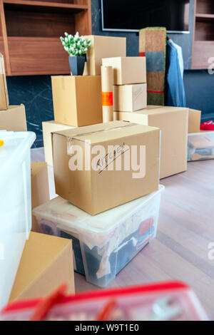 Large living room with stack of moving boxes Stock Photo