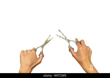 Hands holding pair of open stylish professional barber scissors isolated on white background. Copy space. Top view. Flat lay Stock Photo
