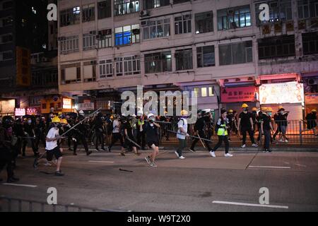 (190815) -- HONG KONG, Aug. 15, 2019 (Xinhua) -- Violent radicals go after a police vehicle in North Point, south China's Hong Hong, Aug. 5, 2019. Two months on, the escalating violence in Hong Kong has taken a heavy toll on the social order. Violent radicals committed acts of vandalism, blocked main traffic lanes, harassed urban commuters and set fires at will. Many have called for a brake to be put on the blatant violence and for order to be restored. (Xinhua) Stock Photo