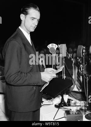 Vintage photo of American business tycoon, pilot, engineer, film producer and philanthropist Howard Hughes (1905 – 1976). The picture was taken as Hughes spoke at a National Press Club luncheon in Washington DC on July 21 1938, a few days after he set an aviation record by completing a round the world flight in just over 91 hours. Stock Photo