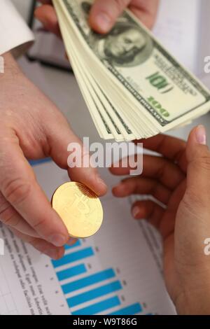 businessmen change currency make successful deal hold money in arms Stock Photo