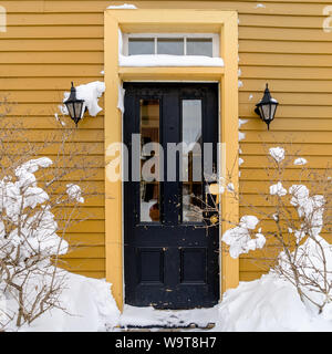 Front entrance of an older home. after a snowfall. Stock Photo