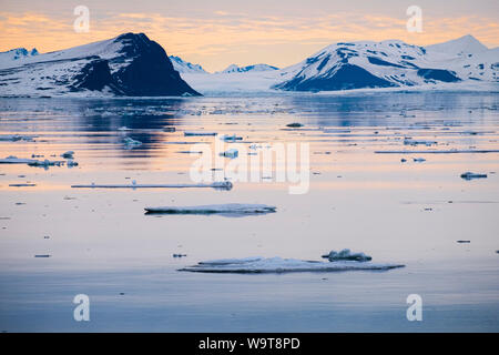 View across sea ice floes in Storfjorden between Spitsbergen island in west and Barentsøya and Edgeøya islands to east in arctic summer. Svalbard Stock Photo