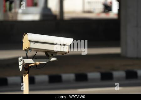 security monitoring CCTV camera mounted on old pole steel post. Stock Photo
