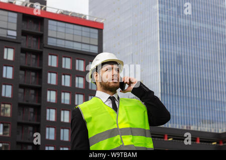 builder engineer talking on the phone businessman serious worker Stock Photo