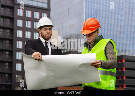 engineer and builder  explaining drawing  architect plan  professional Stock Photo