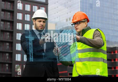 engineer and builder hologram discuss drawing new technologies virtual  business Stock Photo