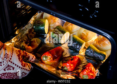 Healthy food. Pepper and zucchini with a ruddy crust are prepared in the oven. Close-up. Grilled vegetables Stock Photo