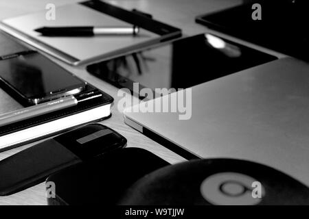 Closeup greyscale shot of technological devices and smartphones Stock Photo