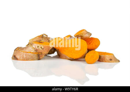 Lot of slices of bright turmeric rhizome heap isolated on white background Stock Photo