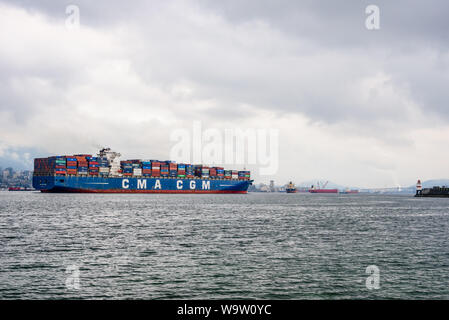 VANCOUVER, BC, CANADA - OCTOBER 30, 2018: The large loaded container ship 'CMA CGM Vela' enters Vancouver Harbour. Stock Photo