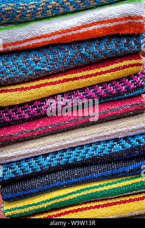 Colorful striped woollen rugs selling on the street Stock Photo