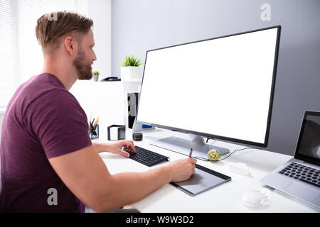 Photo Of Designer Working On Computer In Office Stock Photo