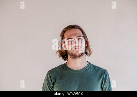 Long haired blonde man smile face, portrait of handsome young guy smiling Stock Photo