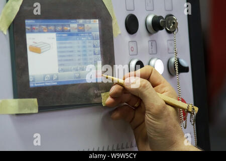 Kharkiv, Ukraine - July 12, 2016: Close-up Control Panel of single sided automatic edge banders in a private furniture workshop, selective focus Stock Photo