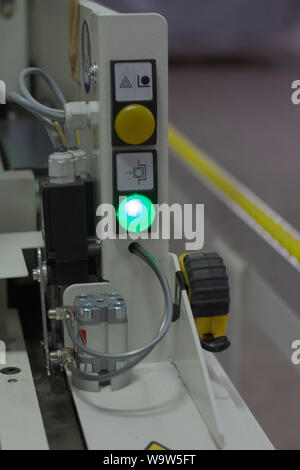 Kharkiv, Ukraine - July 12, 2016: Close-up Control Panel of single sided automatic edge banders in a private furniture workshop, selective focus Stock Photo