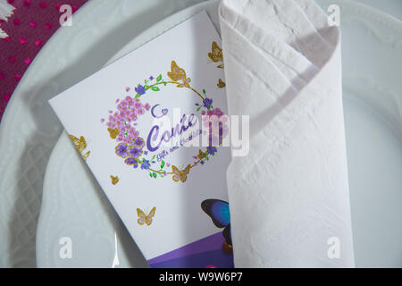 Baku, Azerbaijan - 07.31.2018: Empty plate and kitchen textile napkin. Top view, copy space for text . White craft plate, cutlery and napkin on white Stock Photo