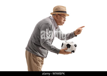 Grumpy old man holding a deflated football and scolding someone isolated on white background Stock Photo