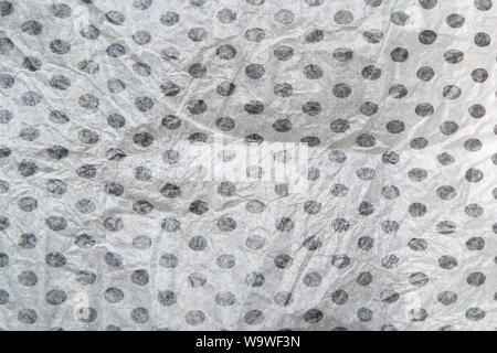 Wrinkled crumpled black polka dot on white wrapping paper texture and background. Stock Photo