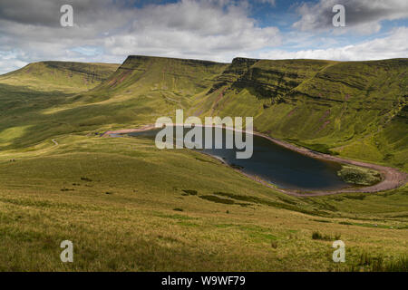 Mountains above the glacial lake, Llyn Y Fan Fach, in Brecon Beacons National Park, Carmarthenshire, Wales Stock Photo