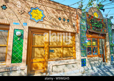 TEHRAN, IRAN - OCTOBER 25, 2017: The building of Azari Teahouse (chaykhaneh) is decorated with relief brick patterns, traditional tile patterns and As Stock Photo