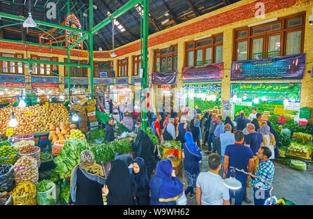 TEHRAN, IRAN - OCTOBER 25, 2017: Busy and noisy hall of Tajrish Bazaar, visitors choose fresh fruits and vegetables, nuts and herbs, on October 25 in Stock Photo