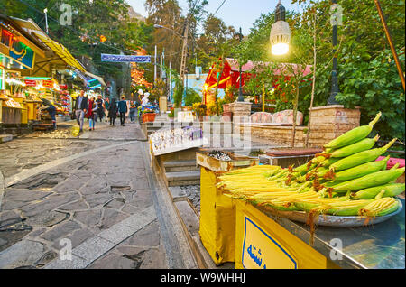 TEHRAN, IRAN - OCTOBER 25, 2017: The small market stall in narrow street of Darband offers fresh corn, on October 25 in Tehran Stock Photo