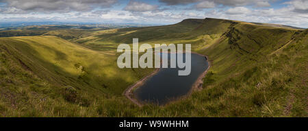 Mountains above the glacial lake, Llyn Y Fan Fach, in Brecon Beacons National Park, Carmarthenshire, Wales Stock Photo