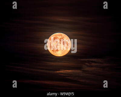 Weather UK: Full Sturgeon Moon rising above Wirksworth, Derbyshire, UK Stock Photo