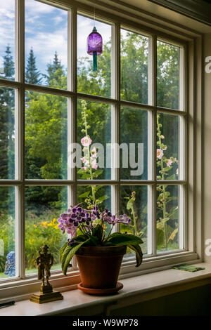 A window with flowers and Fox Glove in a New England farmhouse - BLUE HILL, MAINE Stock Photo