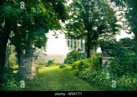 Beautiful green landscape with trees and stone gates Stock Photo