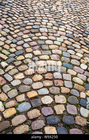 Colorful cobblestone pattern on old European cobbled street Stock Photo