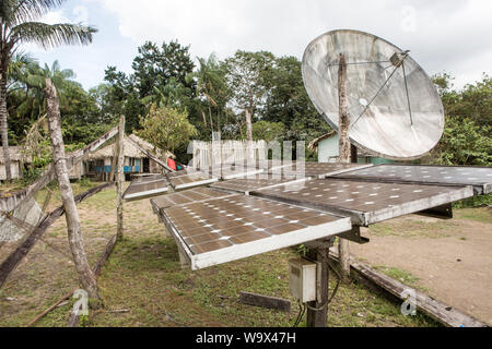 Solar panels generate electricity in village houses of Amazon, Brazil. Concept of environment conservation, climate change, zero carbon emission, clea Stock Photo