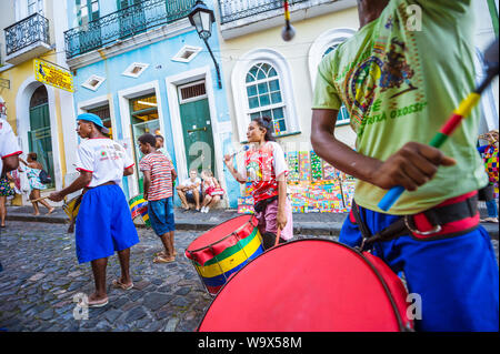 SALVADOR, BRAZIL - MARCH 15, 2018: A group of drummers perform in front of colorful architecture of Pelourinho as part of a social project. Stock Photo