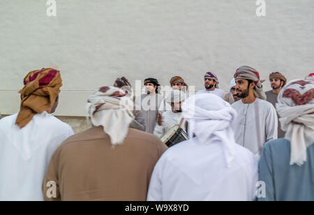 Emirati (Middle Eastern) Men performing a traditional dance in the heritage of the United Arab Emirates - The Yowla Stock Photo