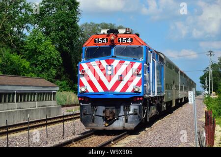 LaFox, Illinois, USA. A Metra locomotive pushing an afternoon train taking commuters to Chicago after leaving the LaFox, Illinois railroad station. Stock Photo