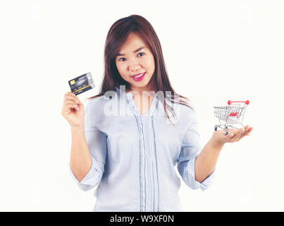 Women holding credit cards and shopping cart, shopping concept Stock Photo