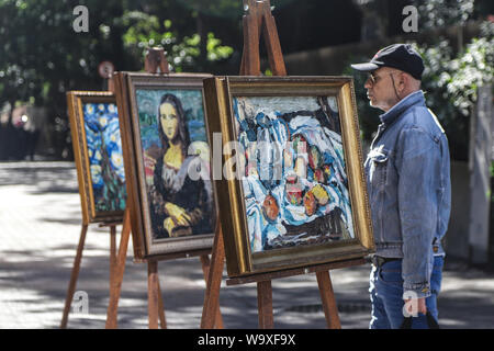 Sao Paulo, Brazil. 15th Aug, 2019. A man stands in front of remakes of famous art works at 'Unwanted Museum' street exhibition in Sao Paulo, Brazil, Aug. 15, 2019. Six remakes of world-famous art works made with plastic bags collected from the city's riversides and recycling cooperatives were displayed during the exhibition, organized to raise awareness of the impact of plastics on nature. Credit: Rahel Patrasso/Xinhua/Alamy Live News Stock Photo