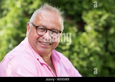 Freital, Germany. 14th Aug, 2019. The German actor Hilmar Eichhorn sits in his garden. Eichhorn celebrates his 65th birthday on 18 August. Credit: Sebastian Kahnert/dpa-Zentralbild/dpa/Alamy Live News Stock Photo