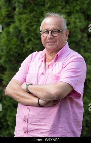 Freital, Germany. 14th Aug, 2019. The German actor Hilmar Eichhorn stands in his garden. Eichhorn celebrates his 65th birthday on 18 August. Credit: Sebastian Kahnert/dpa-Zentralbild/dpa/Alamy Live News Stock Photo