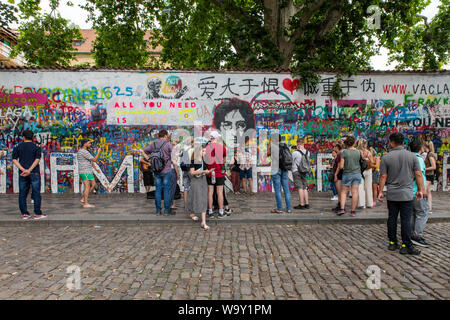 Crowds gather at the John Lennon Wall in Prague, Czech Republic Stock Photo