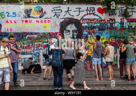 Crowds gather at the John Lennon Wall in Prague, Czech Republic Stock Photo