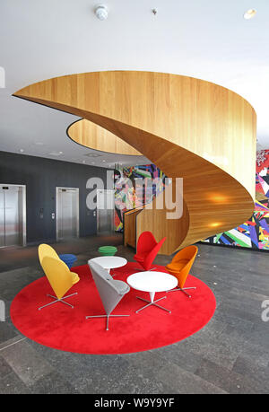 Circular, timber staircase in the ground floor entrance lobby to the Citizen M hotel in Shoreditch, London. Stock Photo