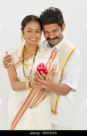 South Indian man giving gift to his wife Stock Photo - Alamy