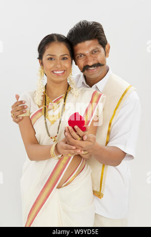 South Indian man giving gift to his wife Stock Photo - Alamy